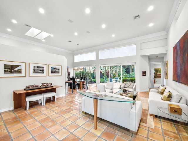 living area featuring a skylight, baseboards, visible vents, and crown molding