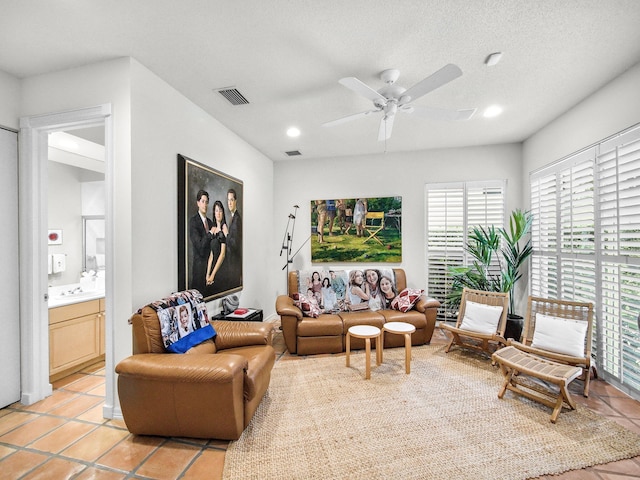 living area featuring recessed lighting, ceiling fan, visible vents, and light tile patterned flooring