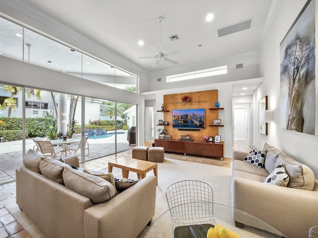 living area with ceiling fan, a towering ceiling, visible vents, and recessed lighting