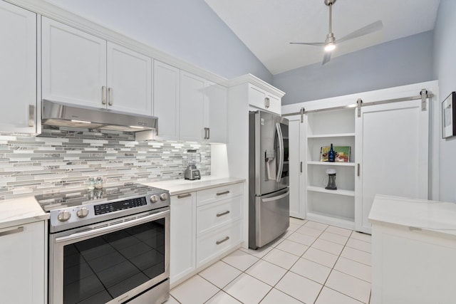 4214 SE Home Way, Port Saint Lucie, FL 34952 - kitchen with decorative backsplash, under cabinet range hood, white cabinets, appliances with stainless steel finishes, and vaulted ceiling