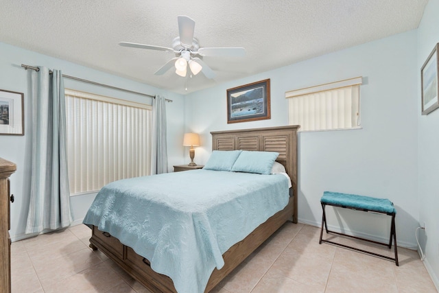 4214 SE Home Way, Port Saint Lucie, FL 34952 - bedroom featuring light tile patterned floors, baseboards, ceiling fan, and a textured ceiling