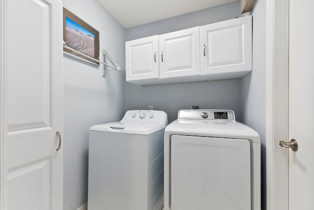 4214 SE Home Way, Port Saint Lucie, FL 34952 - laundry area featuring cabinet space and washing machine and clothes dryer