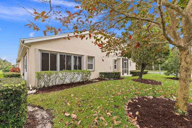 4214 SE Home Way, Port Saint Lucie, FL 34952 - rear view of property with a lawn and stucco siding