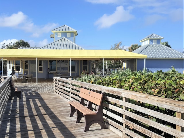 4214 SE Home Way, Port Saint Lucie, FL 34952 - rear view of house featuring a deck, a standing seam roof, and metal roof