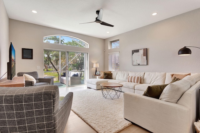 living area with light wood-style floors, a ceiling fan, and recessed lighting