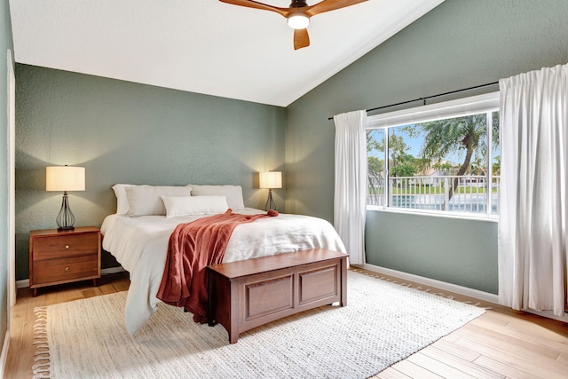 bedroom featuring vaulted ceiling, light wood finished floors, a ceiling fan, and baseboards