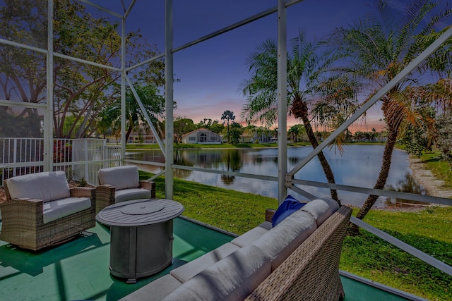 sunroom / solarium featuring a water view