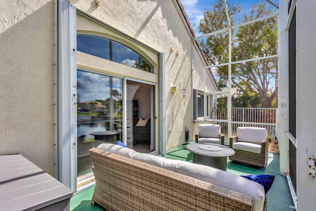 sunroom featuring a wealth of natural light and a water view