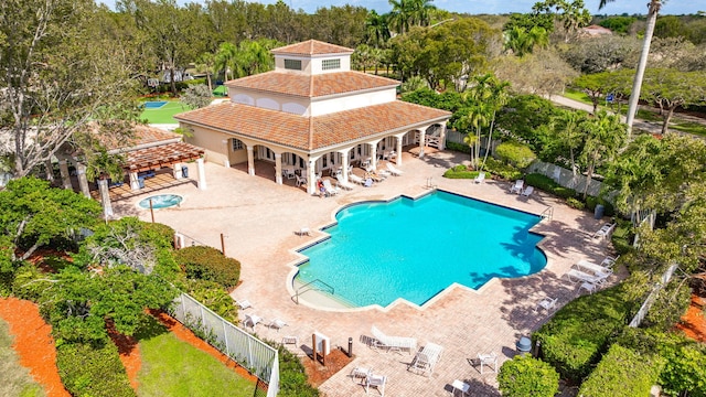 community pool featuring a patio area and fence