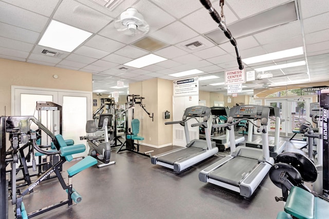 exercise room with french doors, visible vents, baseboards, and a drop ceiling