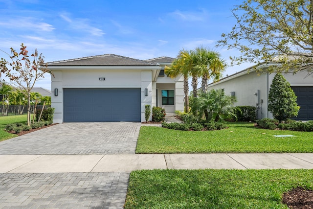 view of front facade featuring a garage, a front lawn, decorative driveway, and stucco siding