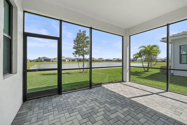 unfurnished sunroom with a water view