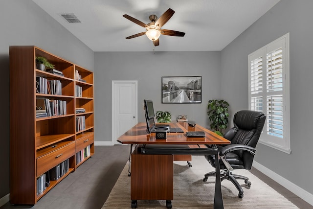 office featuring baseboards, visible vents, and ceiling fan