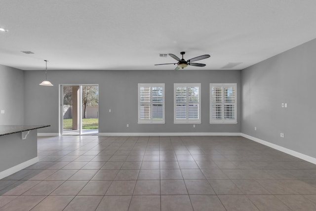 unfurnished room with a ceiling fan, visible vents, a textured ceiling, and light tile patterned flooring