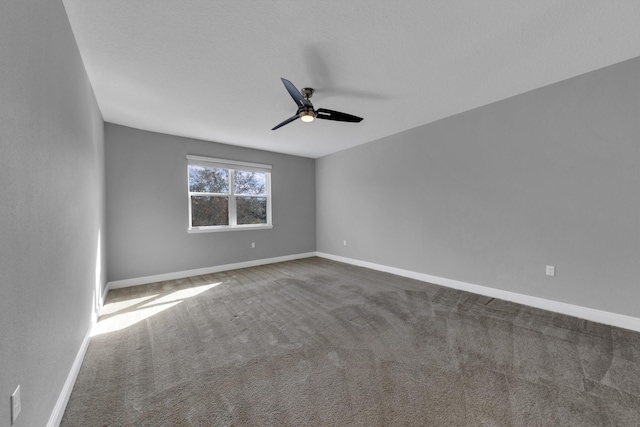 spare room featuring carpet floors, baseboards, and a ceiling fan