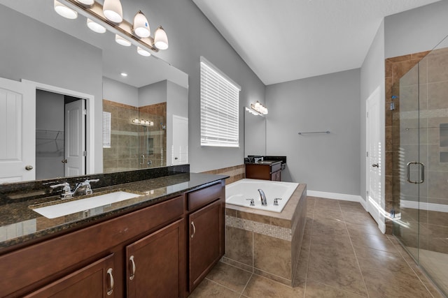 bathroom featuring a shower stall, a walk in closet, tile patterned flooring, and vanity