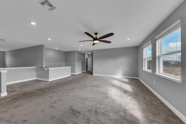 unfurnished room with baseboards, visible vents, ceiling fan, dark carpet, and recessed lighting