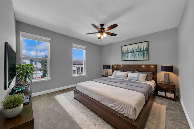 bedroom featuring a ceiling fan, dark carpet, and baseboards