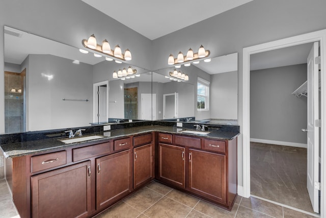 full bath featuring double vanity, tile patterned flooring, a sink, and visible vents