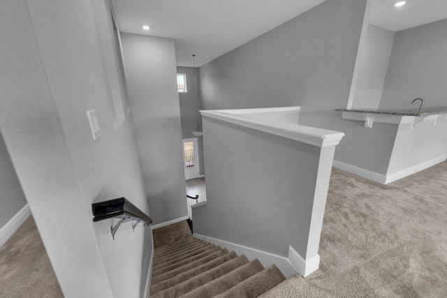 staircase featuring carpet, baseboards, and recessed lighting