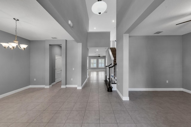 foyer with light tile patterned floors, visible vents, baseboards, and stairs