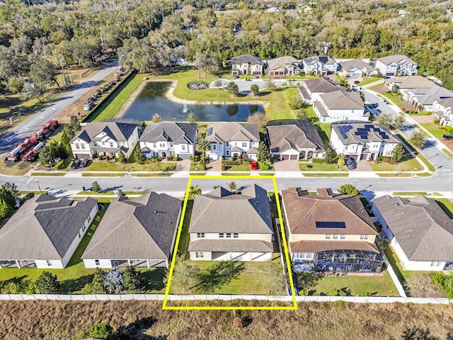 drone / aerial view featuring a water view and a residential view