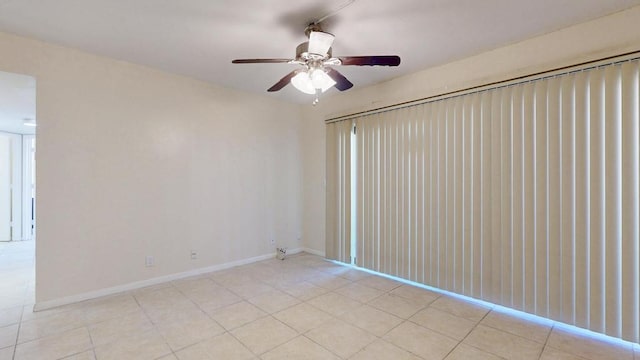 unfurnished room featuring light tile patterned floors, ceiling fan, and baseboards