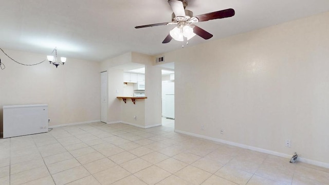 unfurnished room with baseboards, visible vents, and light tile patterned flooring