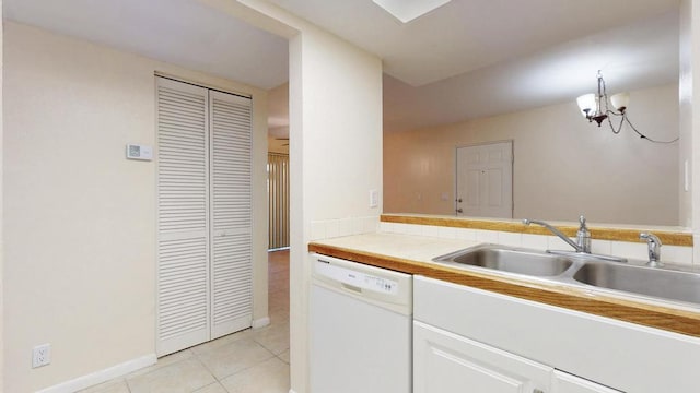 kitchen with light countertops, white cabinets, light tile patterned flooring, a sink, and dishwasher