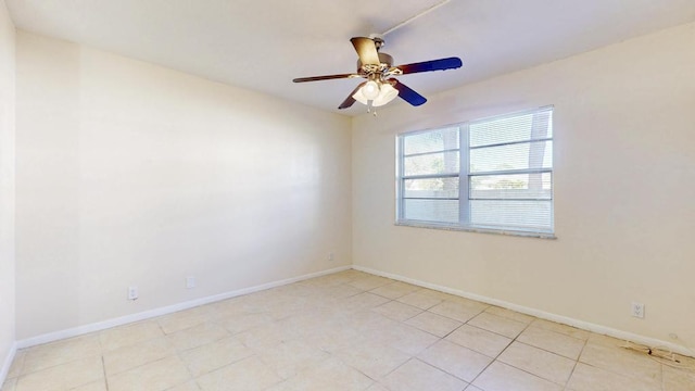 unfurnished room with light tile patterned floors, baseboards, and a ceiling fan