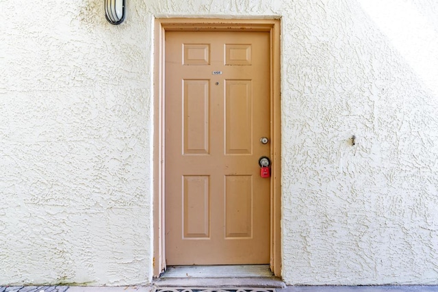 property entrance featuring stucco siding