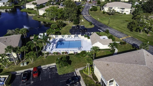 drone / aerial view with a water view and a residential view