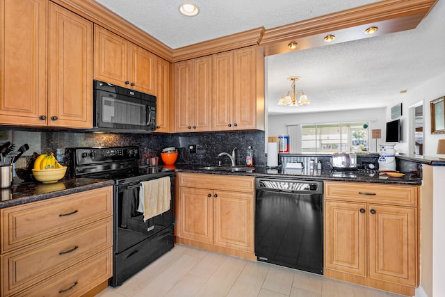 kitchen featuring decorative backsplash, dark stone countertops, a peninsula, black appliances, and a sink