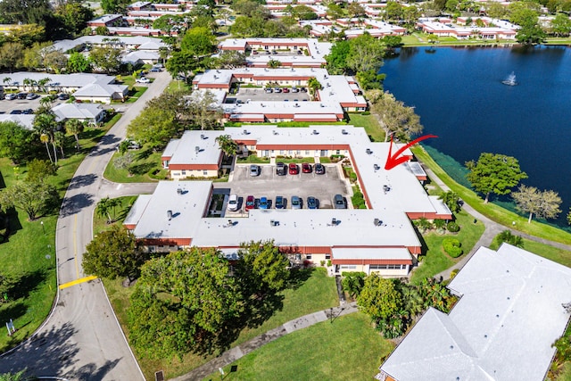 bird's eye view featuring a water view and a residential view