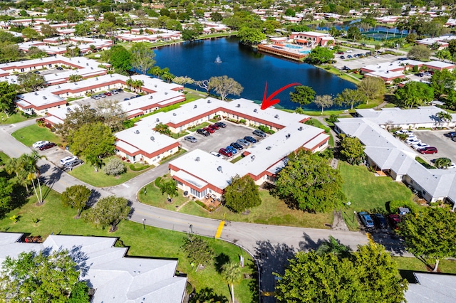 birds eye view of property with a water view and a residential view