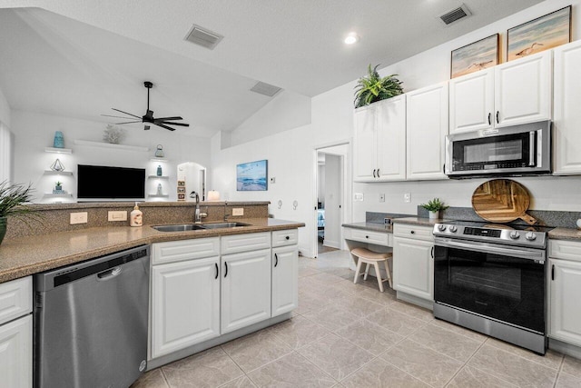 kitchen with stainless steel appliances, white cabinetry, and a sink