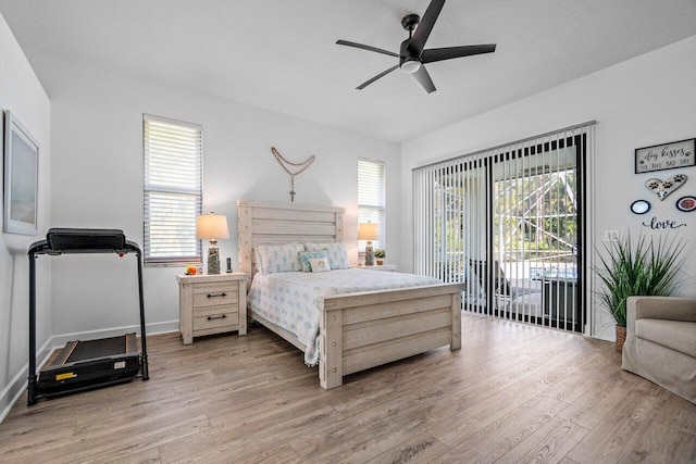 bedroom featuring light wood-style floors, access to outside, and a textured ceiling