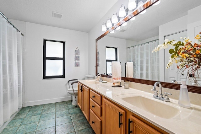 bathroom featuring tile patterned flooring, visible vents, a sink, and toilet