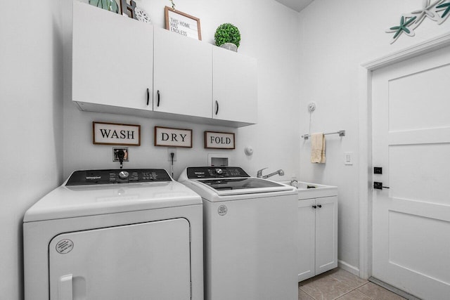 laundry room featuring light tile patterned flooring, cabinet space, a sink, and separate washer and dryer