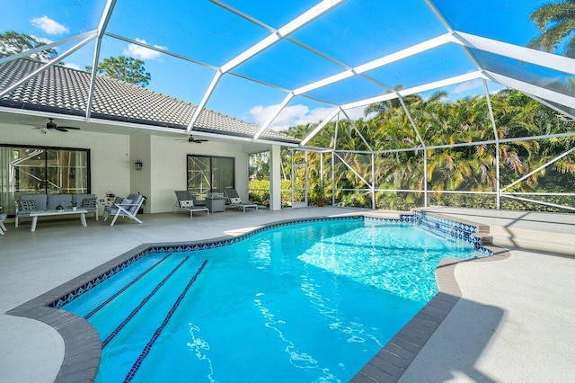 pool featuring a lanai, a patio area, and ceiling fan