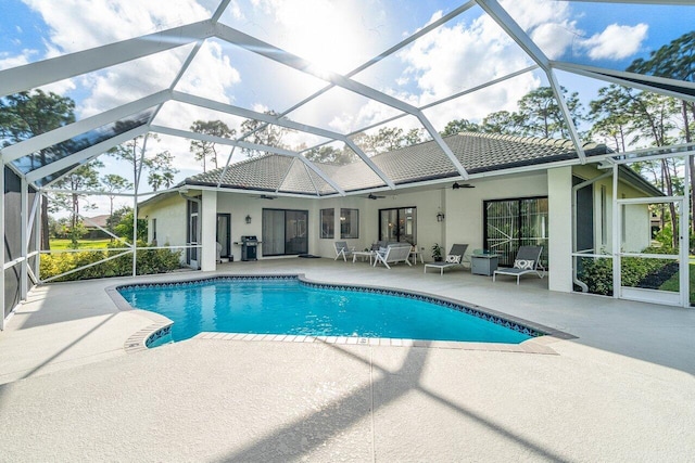 pool with ceiling fan, a patio, grilling area, and a lanai