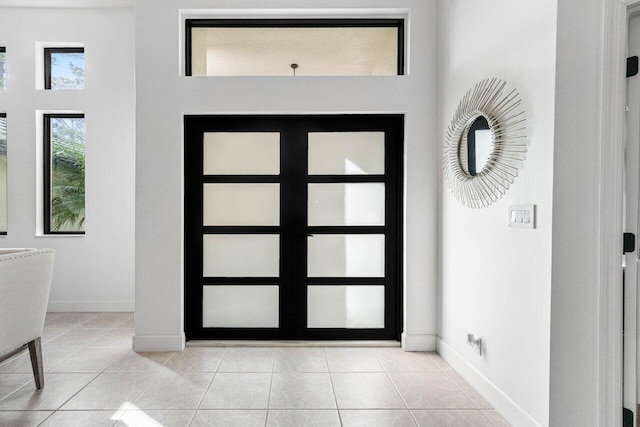 entryway featuring baseboards and light tile patterned floors