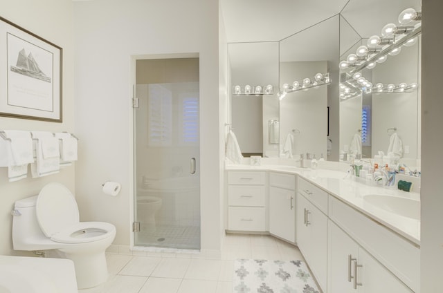 bathroom with double vanity, a stall shower, a sink, and tile patterned floors