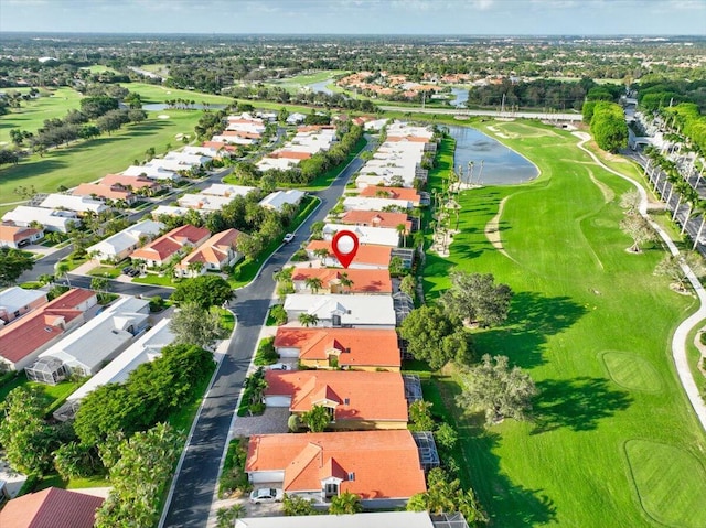 birds eye view of property featuring view of golf course, a water view, and a residential view