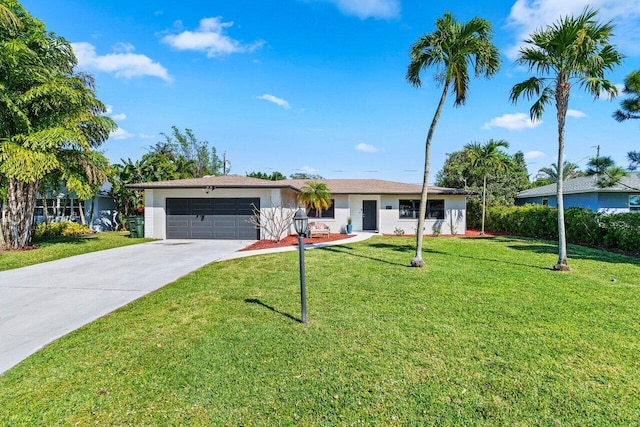 ranch-style home with a garage, stucco siding, concrete driveway, and a front yard