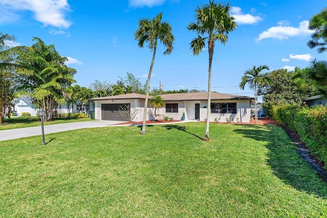 single story home with a garage, concrete driveway, a front yard, and fence