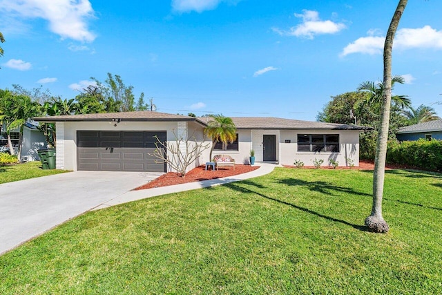 ranch-style house featuring a garage, stucco siding, concrete driveway, and a front yard