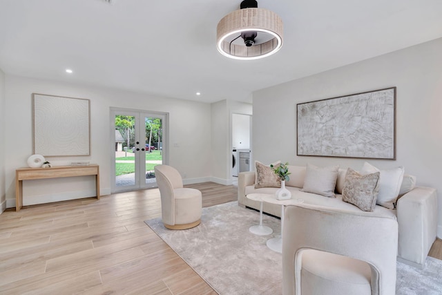 living area featuring french doors, recessed lighting, washer / clothes dryer, light wood-type flooring, and baseboards