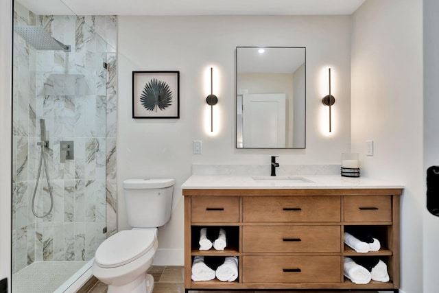 full bathroom with toilet, baseboards, a walk in shower, and vanity