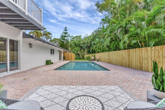 view of pool featuring fence, a fenced in pool, and a patio